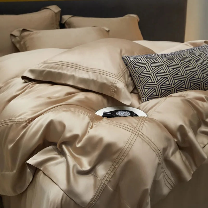 Beige bedding set with a linear patterned pillow on a bed.